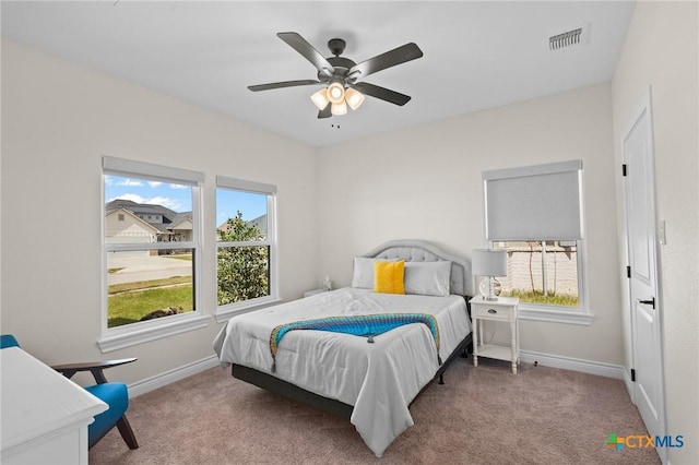 bedroom with ceiling fan, carpet floors, visible vents, and baseboards