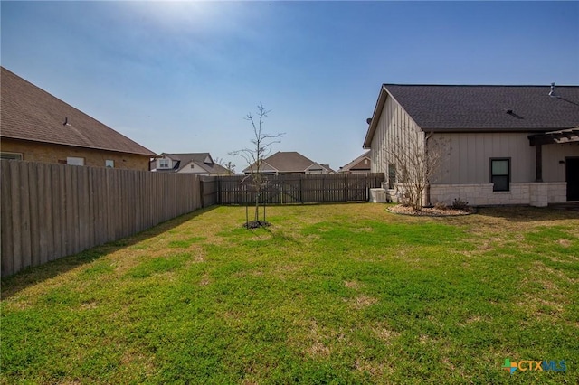 view of yard with a fenced backyard