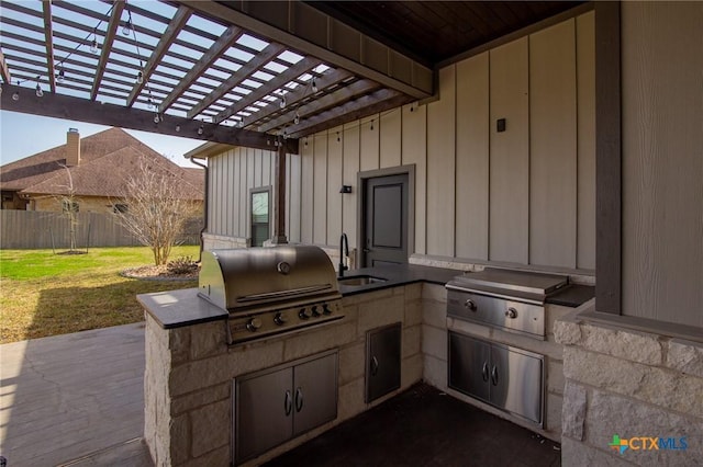 view of patio / terrace featuring a sink, grilling area, area for grilling, and fence