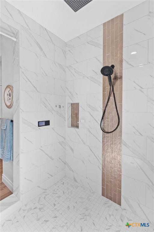 bathroom with a marble finish shower