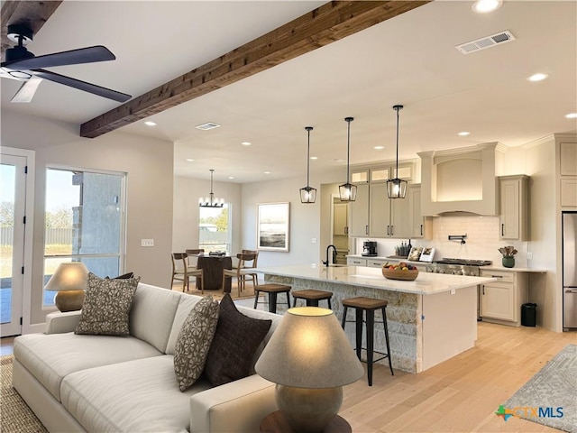 713 San Gabriel Ranch Rd, Liberty Hill, TX 78641 - kitchen featuring premium range hood, light wood-type flooring, a breakfast bar, a ceiling fan, and recessed lighting