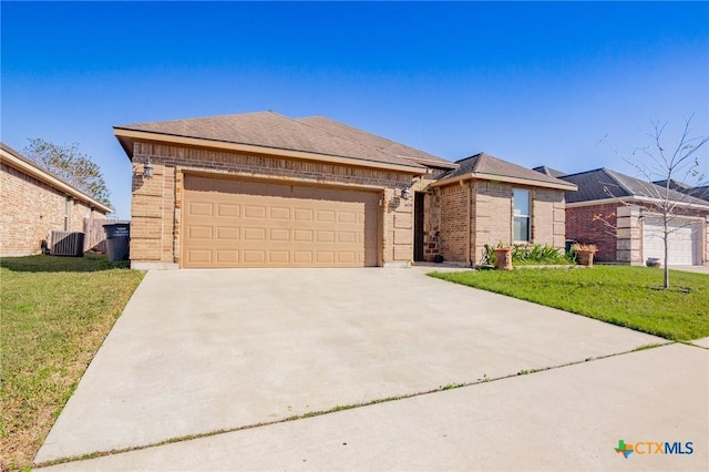 ranch-style house with cooling unit, a garage, and a front lawn