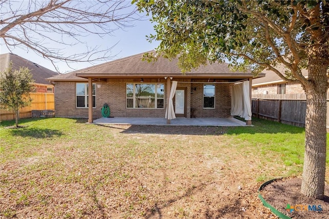 back of property featuring a patio and a lawn