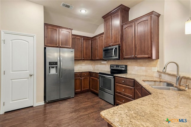 kitchen featuring dark hardwood / wood-style flooring, backsplash, stainless steel appliances, and sink