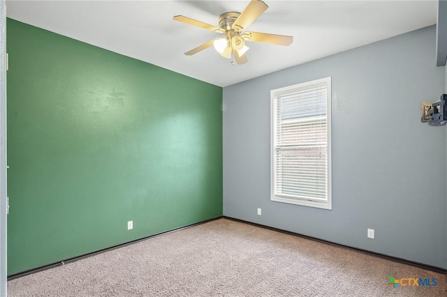 empty room with carpet and ceiling fan