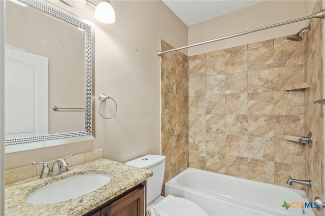 full bathroom featuring toilet, vanity, and tiled shower / bath