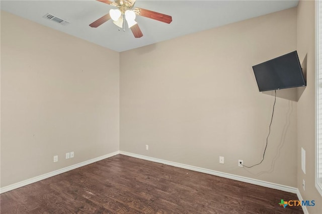 empty room with dark hardwood / wood-style floors and ceiling fan