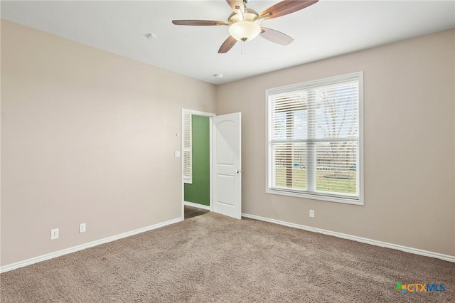 empty room featuring carpet flooring and ceiling fan