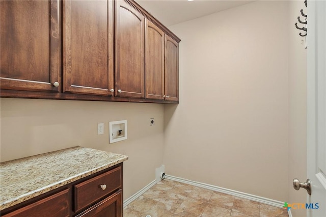 clothes washing area with hookup for an electric dryer, cabinets, and hookup for a washing machine