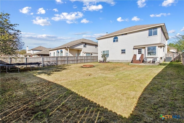 229 Rocky Ridge Dr, New Braunfels, TX 78130 - back of house featuring a trampoline, entry steps, cooling unit, and a fire pit