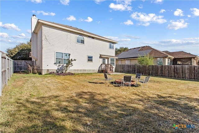 229 Rocky Ridge Dr, New Braunfels, TX 78130 - rear view of property with a chimney and a fire pit