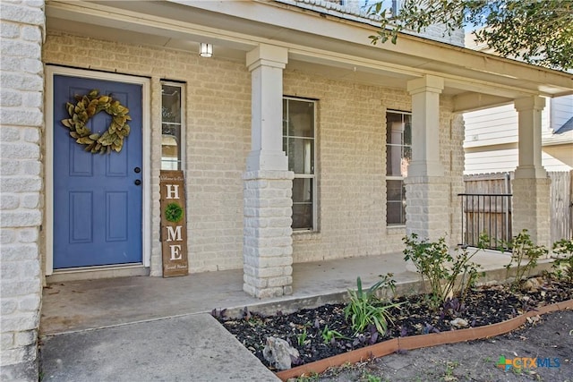 229 Rocky Ridge Dr, New Braunfels, TX 78130 - doorway to property with a porch, brick siding, and fence