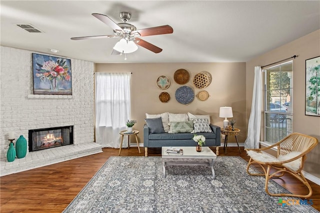 229 Rocky Ridge Dr, New Braunfels, TX 78130 - living room with baseboards, wood finished floors, ceiling fan, and a brick fireplace