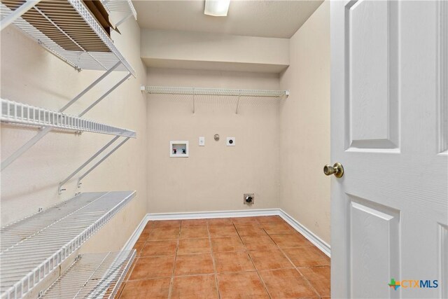 229 Rocky Ridge Dr, New Braunfels, TX 78130 - washroom with hookup for an electric dryer, washer hookup, hookup for a gas dryer, tile patterned floors, and baseboards