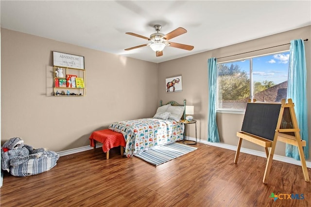 229 Rocky Ridge Dr, New Braunfels, TX 78130 - bedroom with wood finished floors, baseboards, and a ceiling fan