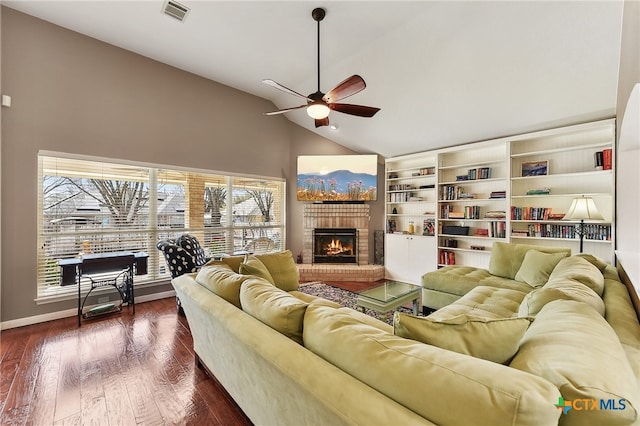 living room with a ceiling fan, visible vents, high vaulted ceiling, dark wood-style flooring, and a brick fireplace