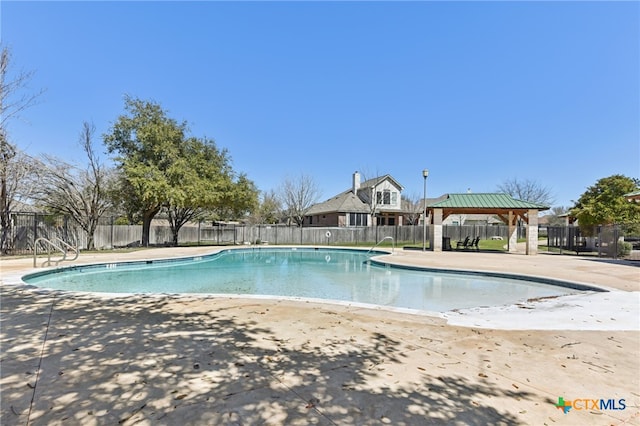 pool featuring a gazebo and fence