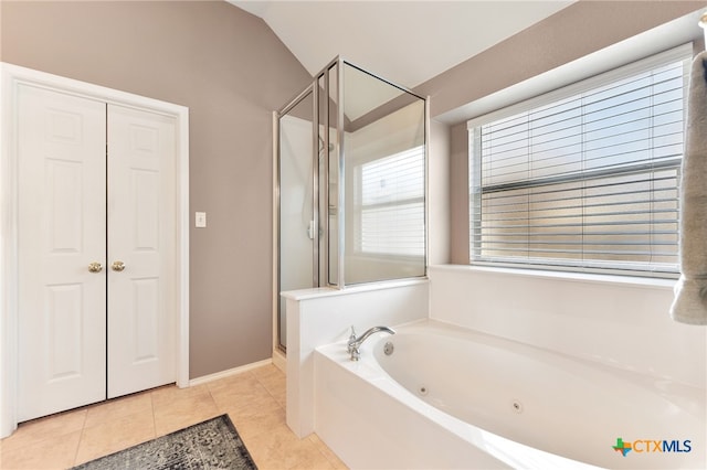 full bathroom featuring tile patterned floors, lofted ceiling, a whirlpool tub, and a shower stall