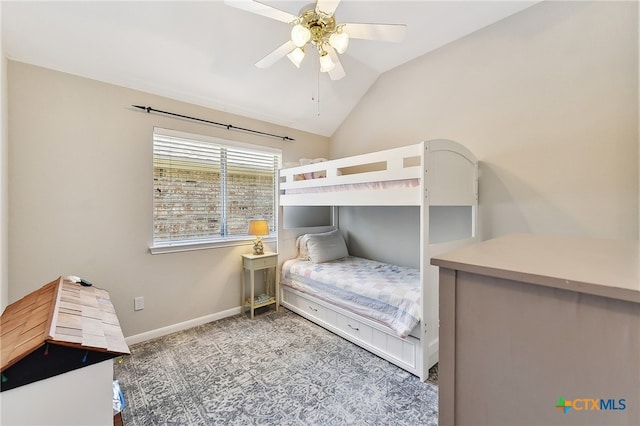 carpeted bedroom featuring vaulted ceiling, baseboards, and ceiling fan