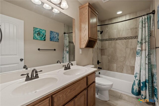 full bath with tile patterned flooring, a sink, shower / bathtub combination with curtain, and toilet
