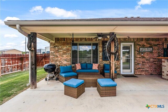 view of patio featuring grilling area, ceiling fan, fence, and outdoor lounge area