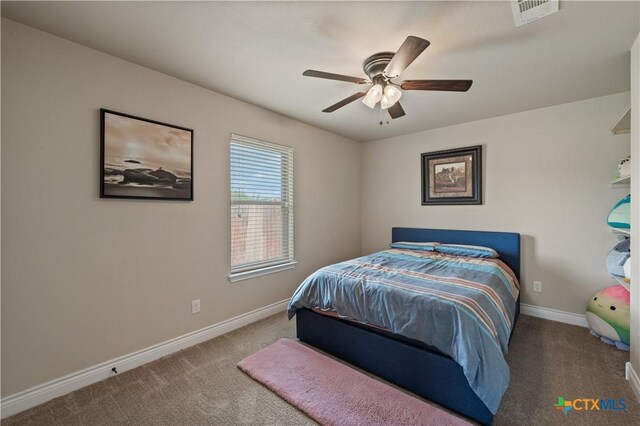 bedroom featuring visible vents, carpet flooring, baseboards, and ceiling fan