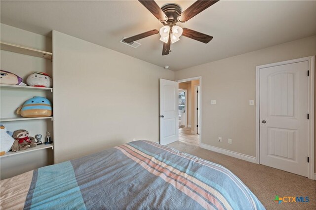 carpeted bedroom featuring visible vents, baseboards, and ceiling fan