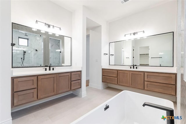 bathroom with vanity and separate shower and tub