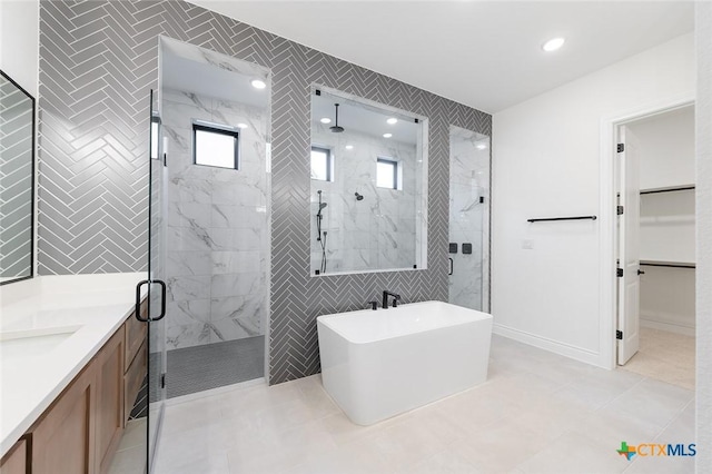 bathroom with vanity, tile patterned floors, and independent shower and bath