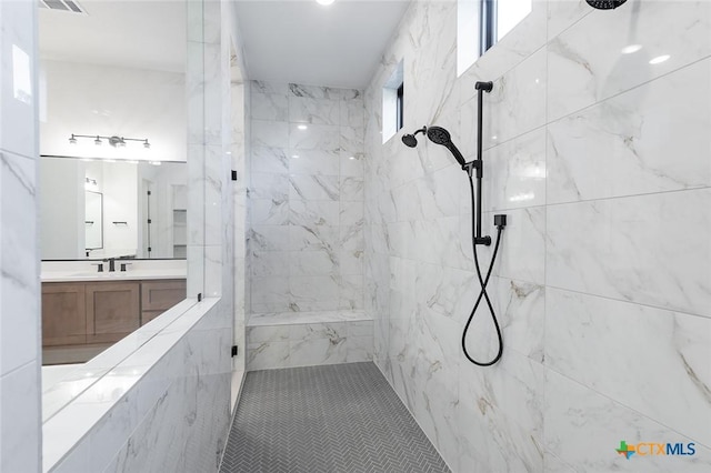 bathroom featuring vanity and a tile shower