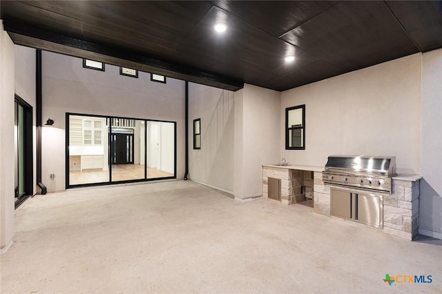 view of patio / terrace with an outdoor kitchen, a grill, and sink