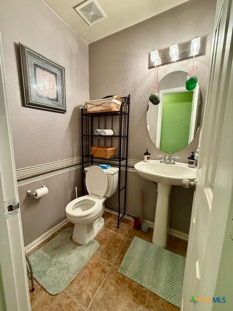 bathroom with sink, tile patterned floors, and toilet