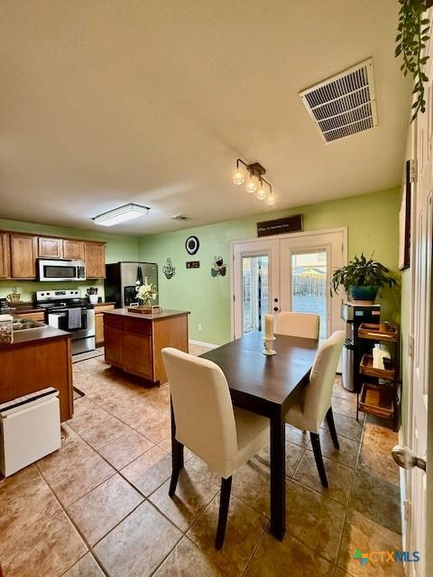 tiled dining room with french doors