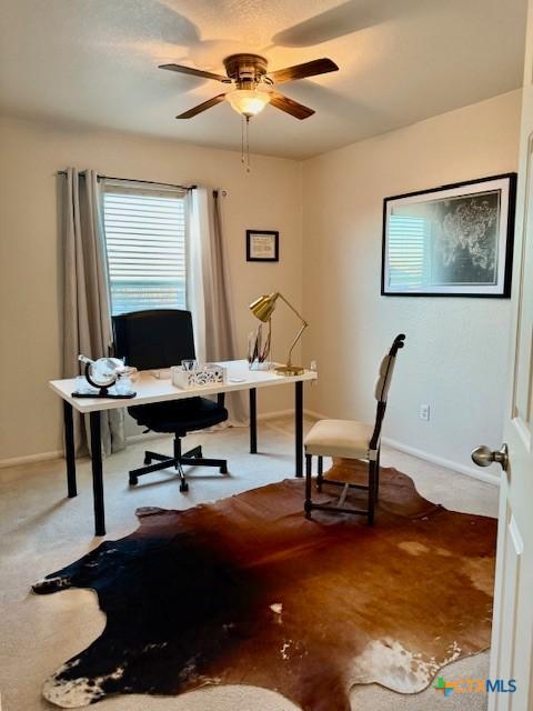 home office featuring ceiling fan and carpet flooring