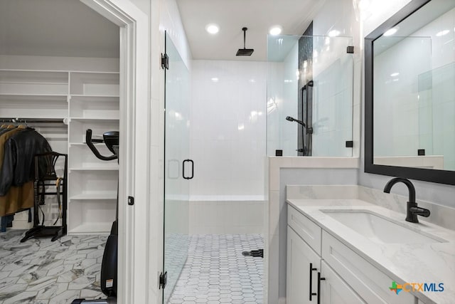 bathroom featuring vanity and a shower with door