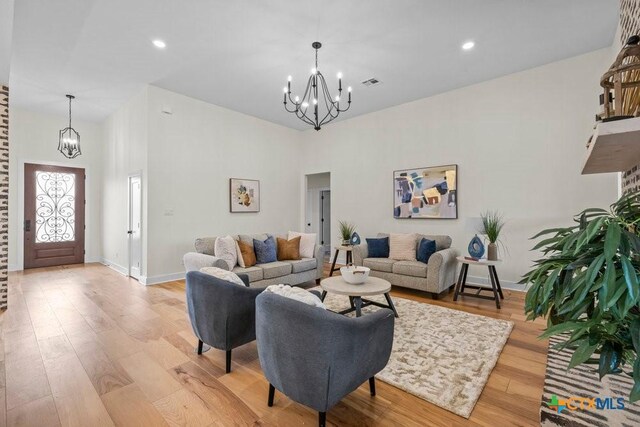 dining area featuring light wood-type flooring and a notable chandelier