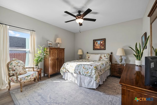 bedroom with ceiling fan and dark hardwood / wood-style floors