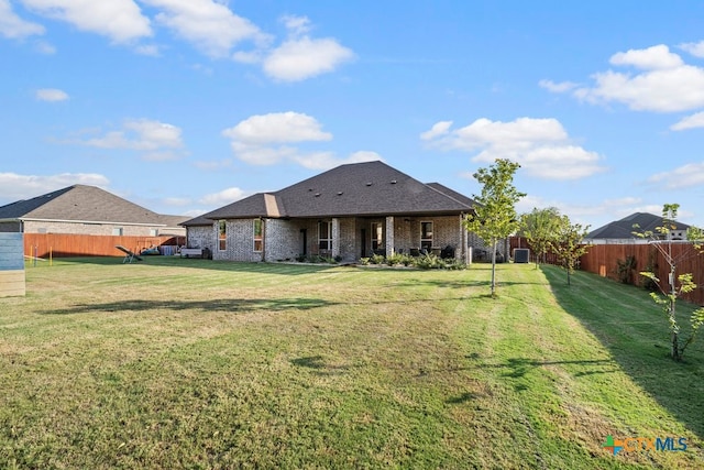 back of house with a lawn