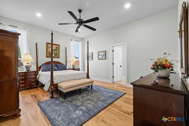 bedroom with light hardwood / wood-style floors and ceiling fan