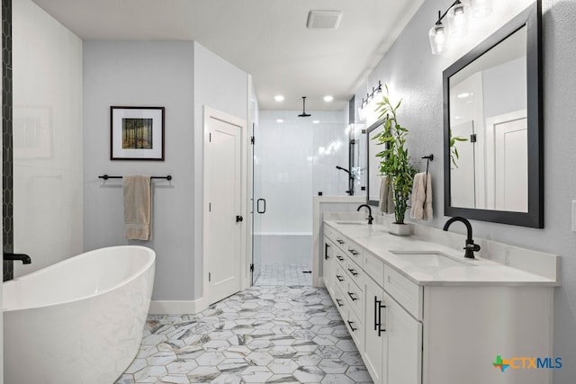 bathroom with vanity and shower with separate bathtub