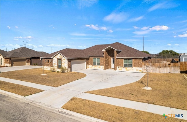 single story home with a garage, brick siding, fence, driveway, and stone siding