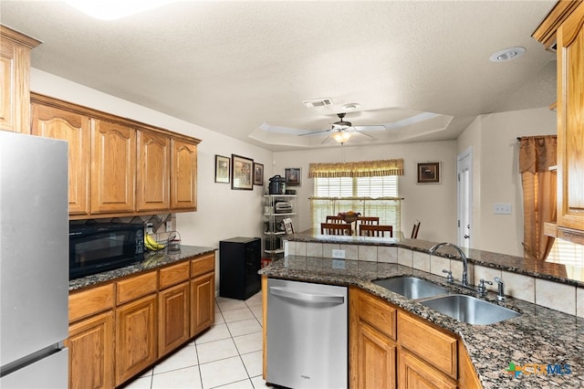 2004 Excel Dr, Killeen, TX 76542 - kitchen with stainless steel appliances, a raised ceiling, backsplash, a ceiling fan, and dark stone countertops