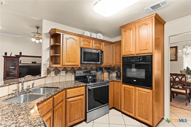 2004 Excel Dr, Killeen, TX 76542 - kitchen featuring appliances with stainless steel finishes, dark stone countertops, tasteful backsplash, light tile patterned flooring, and ceiling fan