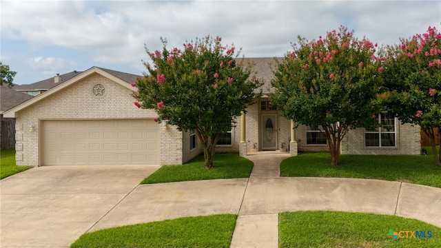 2004 Excel Dr, Killeen, TX 76542 - obstructed view of property with an attached garage, driveway, a front lawn, and brick siding