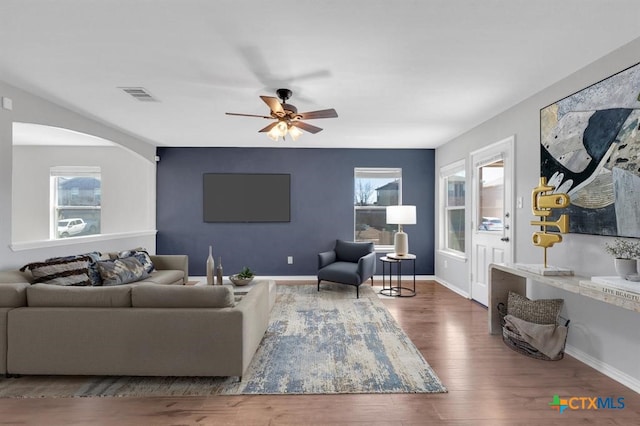 9301 Bellgrove Ct, Killeen, TX 76542 - living area featuring wood finished floors, a ceiling fan, baseboards, and arched walkways