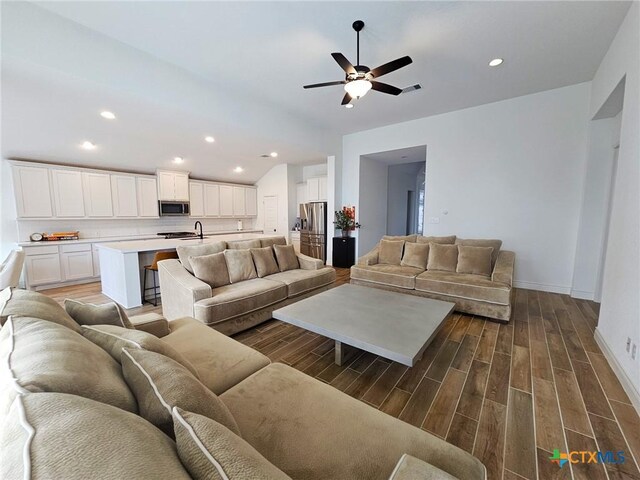 2961 Grove Way, Seguin, TX 78155 - living area featuring lofted ceiling, wood finished floors, ceiling fan, and recessed lighting