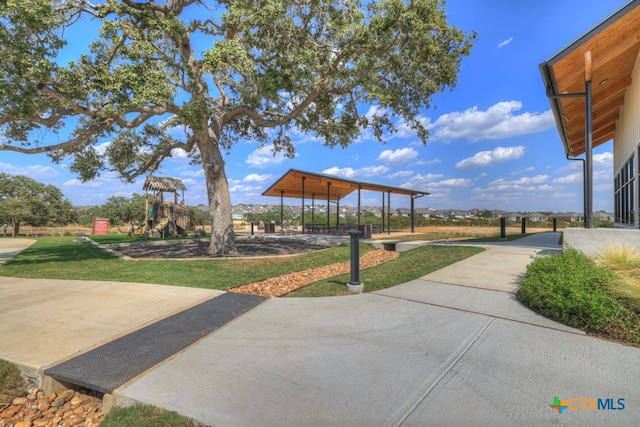 view of home's community with a playground and a yard