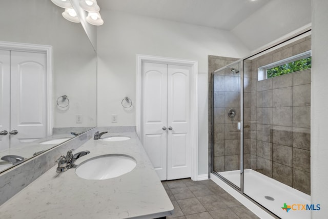 bathroom with walk in shower, tile patterned flooring, lofted ceiling, and vanity