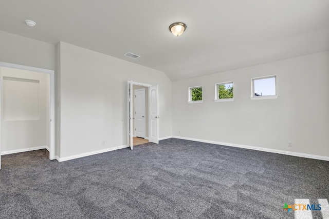 unfurnished bedroom with dark colored carpet