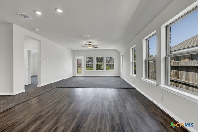 unfurnished living room with ceiling fan and dark hardwood / wood-style floors